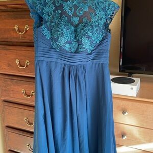 Off blue , dark turquoise medium to large size, padded adjustable back strap.